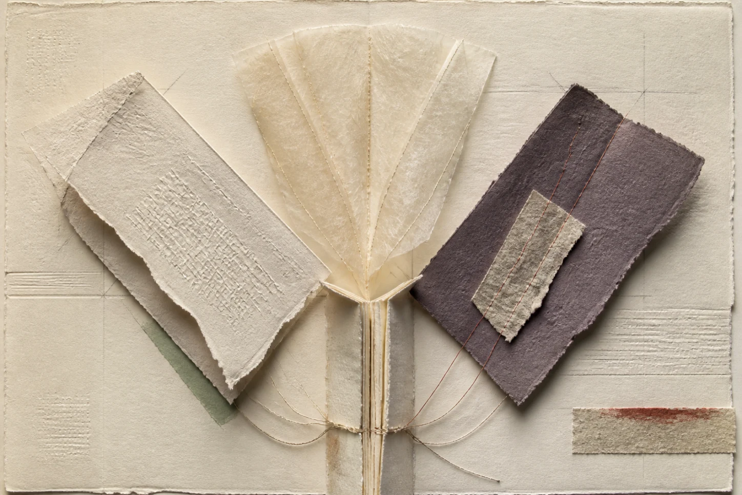 Handmade paper planes unfold from one bound source into three distinct reading surfaces